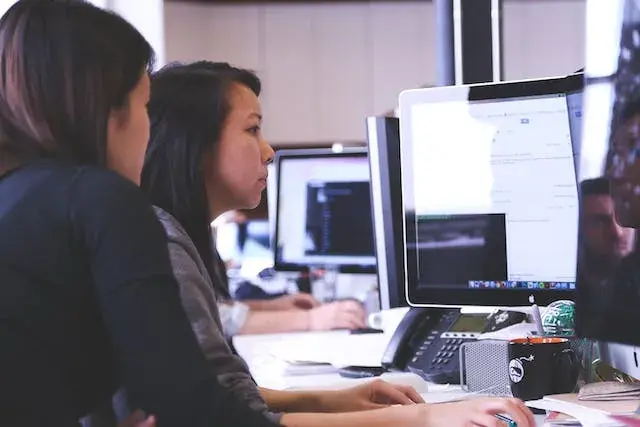 women-working-together-in-front-of-the-computer