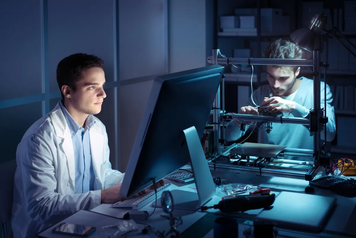 2 boys working on computer